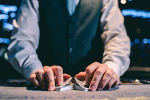 Dealer with cards in casino